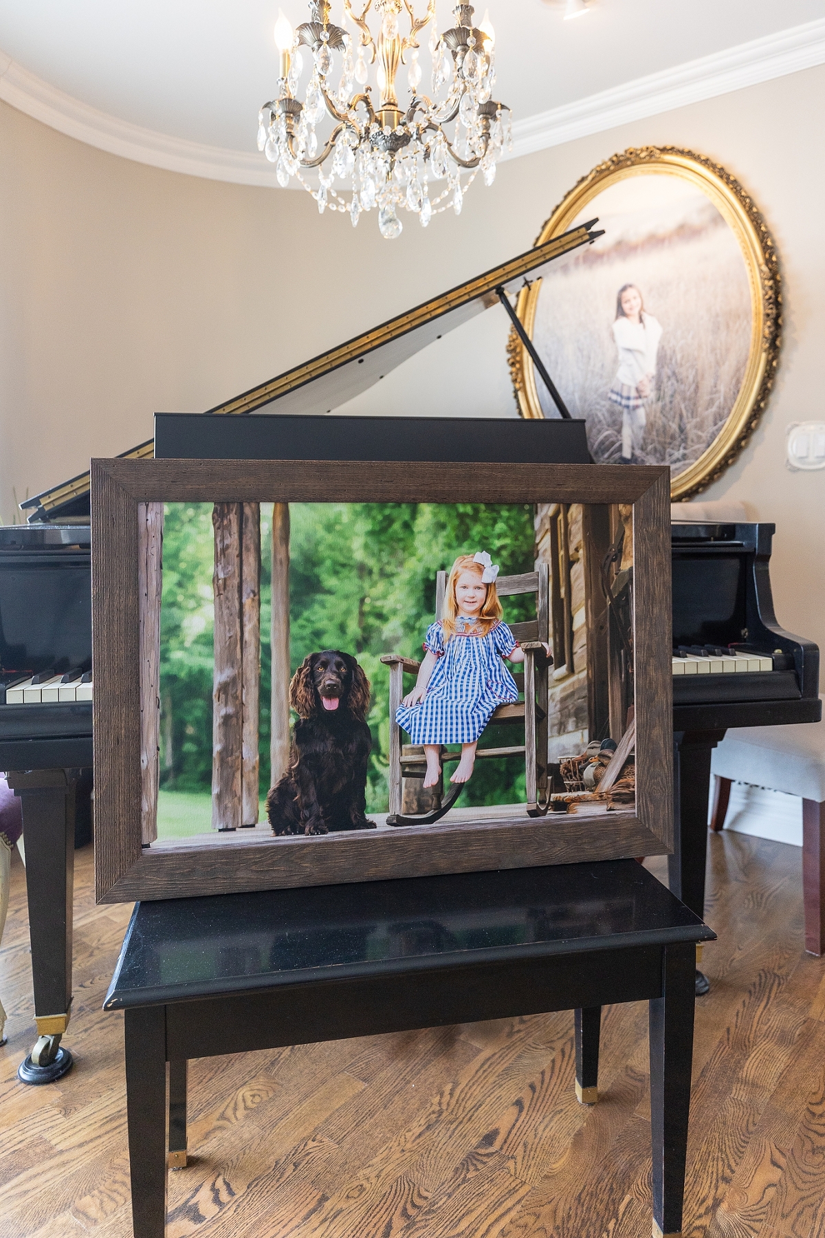 A framed photo of a child and a dog displayed on a grand piano in an elegant room.