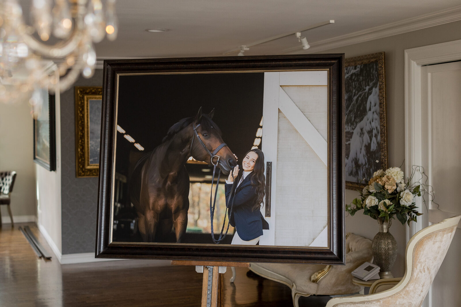 A framed photo of a horse in a room.