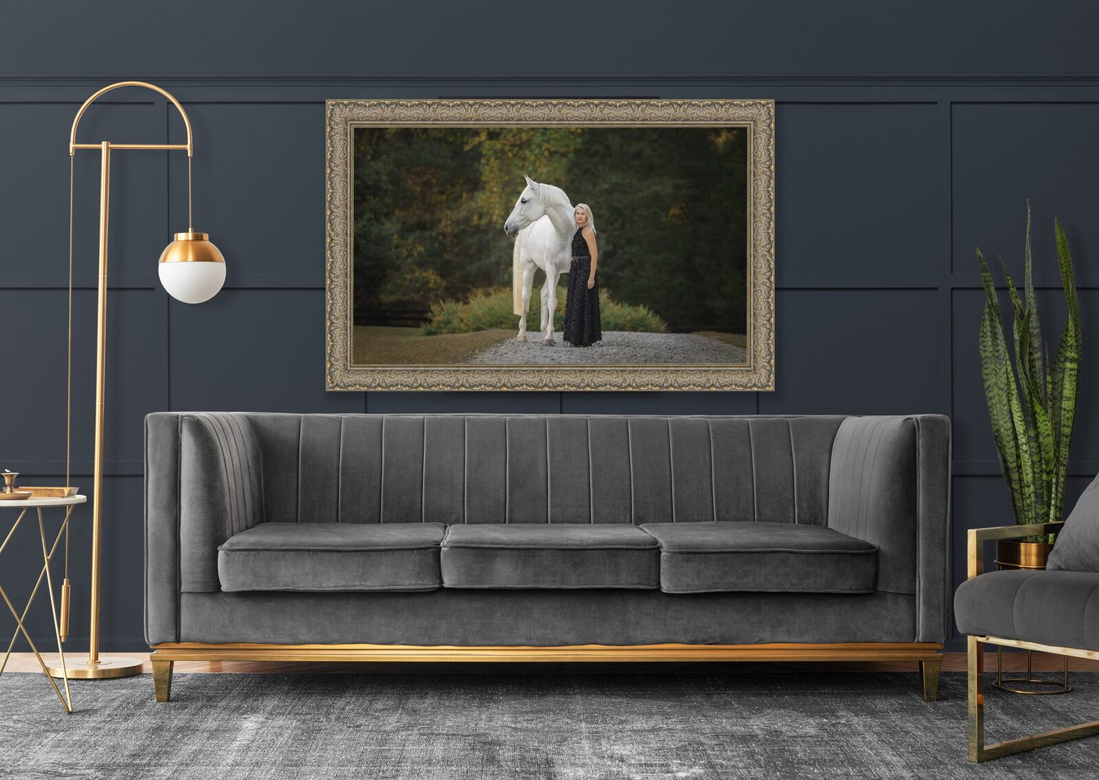 A modern living room with a gray sofa, an elegant floor lamp, and a framed painting of a woman with a white horse on a wall.